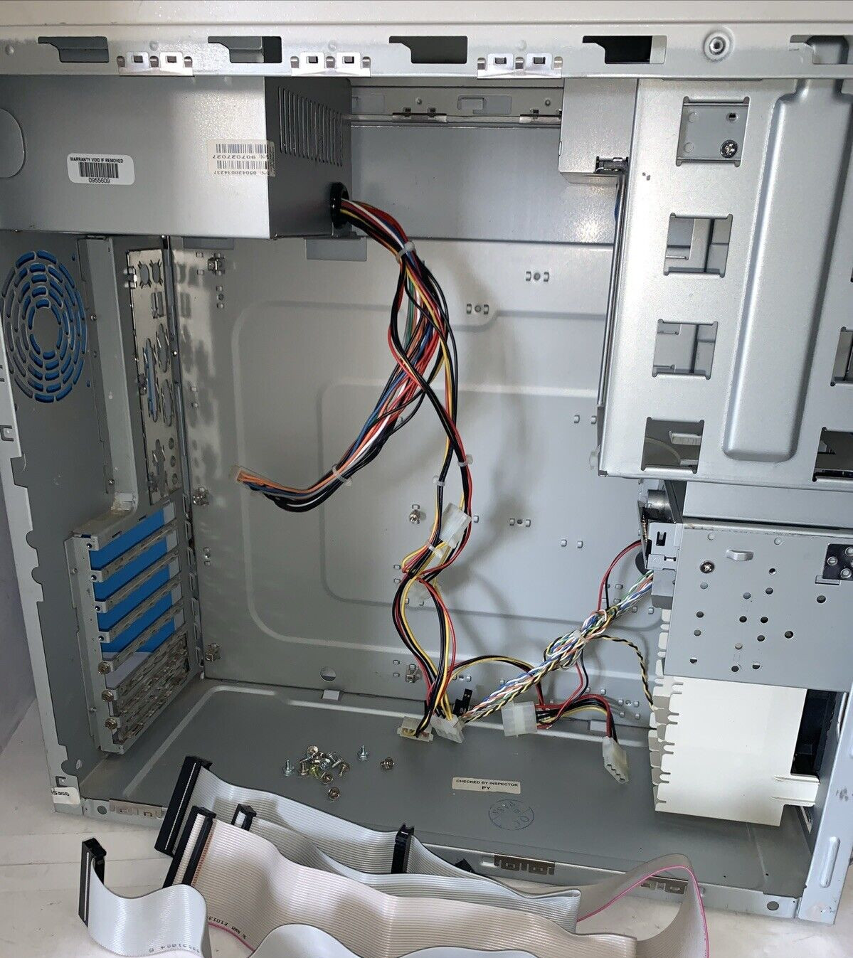 The inside of the same old PC case. Its layout is extremely pragmatic: motherboard in the very bottom corner, PSU in the top corner above it, and all the drive bay mounts are in a cage lining the front side. In other words, it looks like an old PC case.