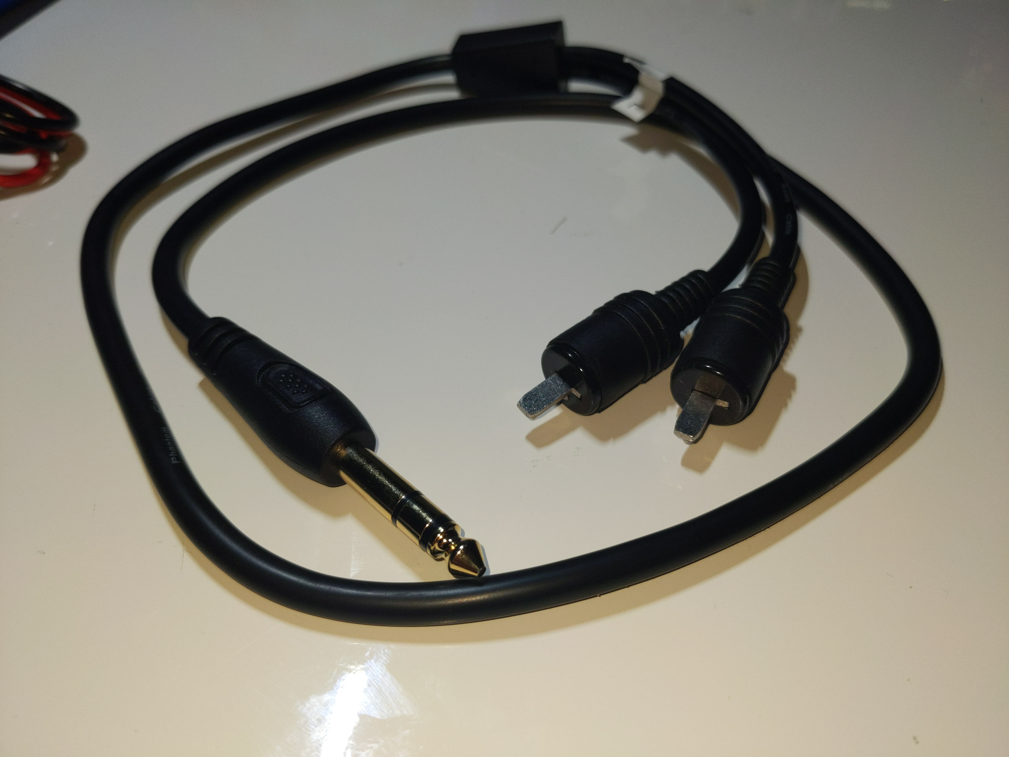 A Stereo 1/4 inch TRS to dual mono 2-pin DIN adapter cable